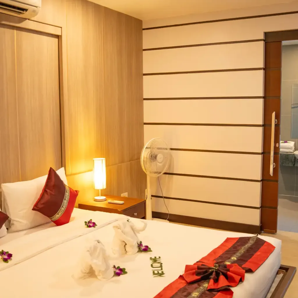 King bedroom with warm lighting and ensuite