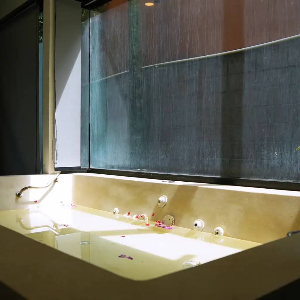 Corner spa bath with a tropical flower and petals